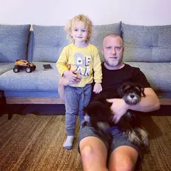 On the floor at home with my son and our dog.